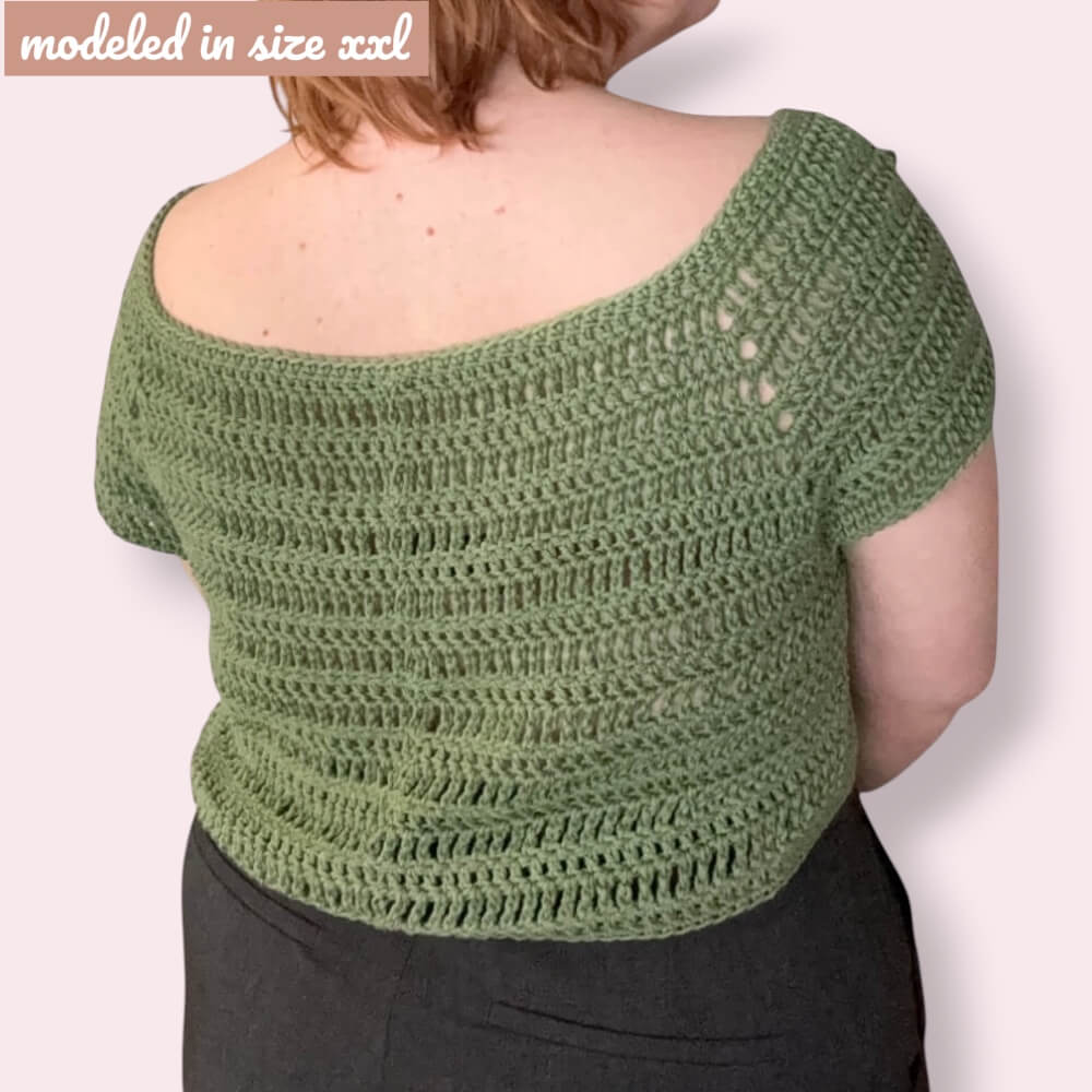 Person wearing crochet tee with «modeled in size XXL» overlayed