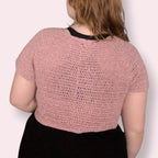 Person wearing pink crochet tshirt back view