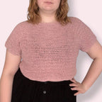 Person wearing pink crochet tshirt front view