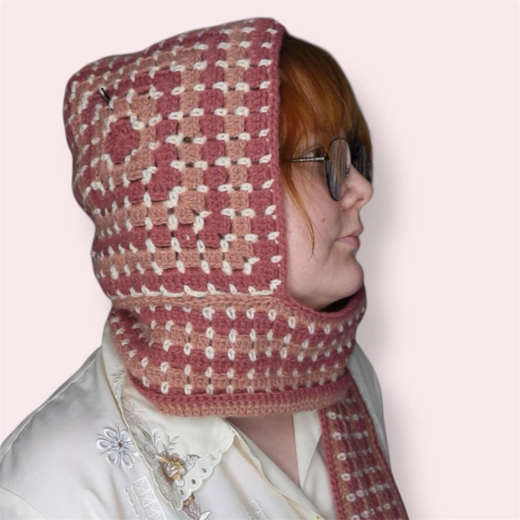 Person wearing pink hooded scarf closeup