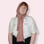 Person wearing pink hooded scarf front view