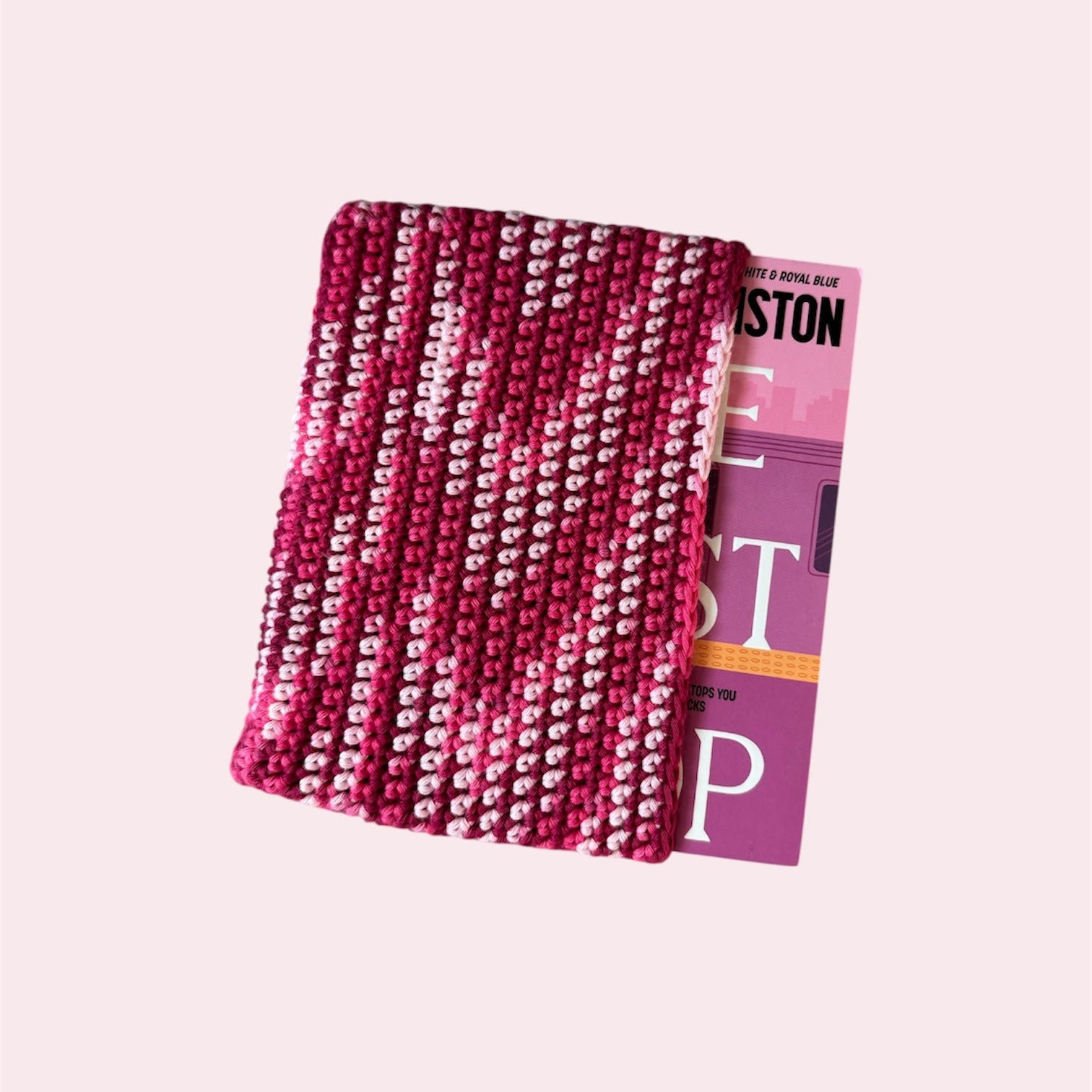 Pink book sleeve with a book inside on a pink background