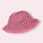 Pink crochet bucket hat on plain background