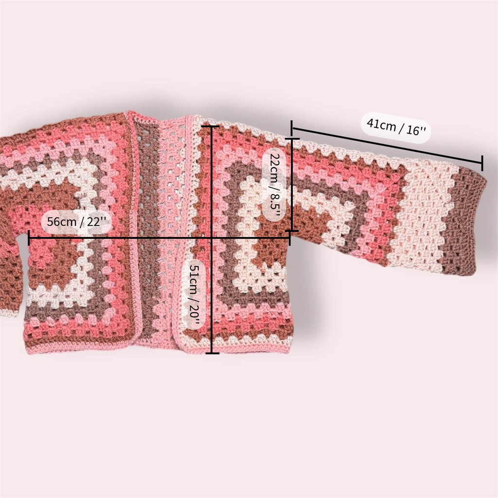 Pink crochet cardigan with measurements on plain background