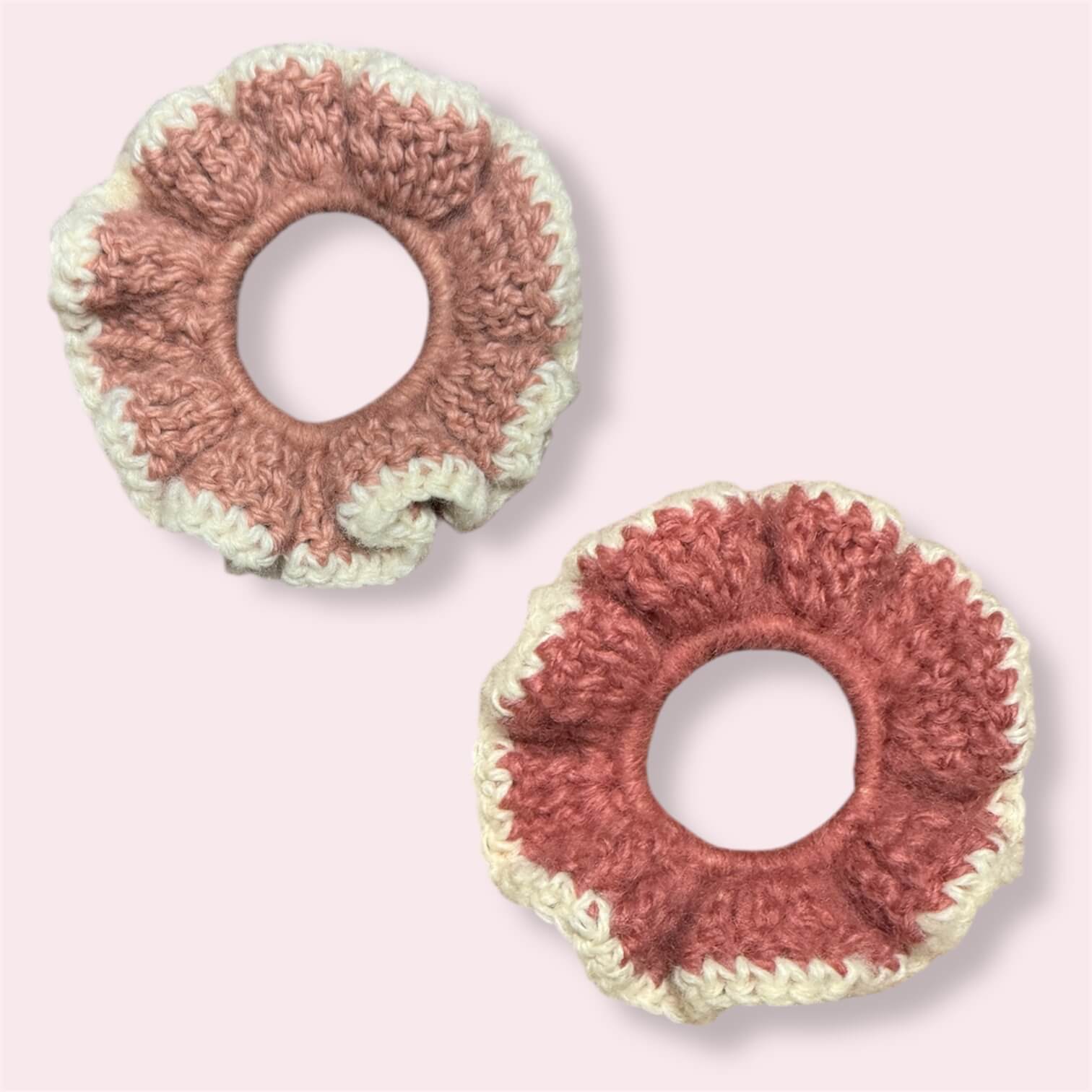 Pink crochet scrunchies on plain background