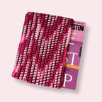 Pink crocheted book sleeve with a book inside top view
