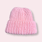 Pink handmade pink beanie on plain background