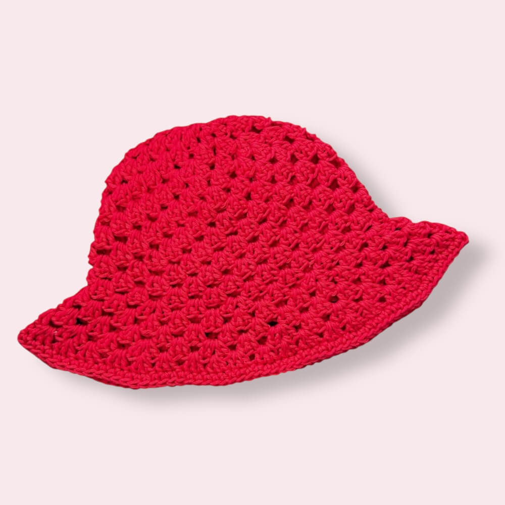 Red crochet bucket hat on plain background