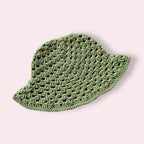 Sage green crocheted bucket hat on plain background