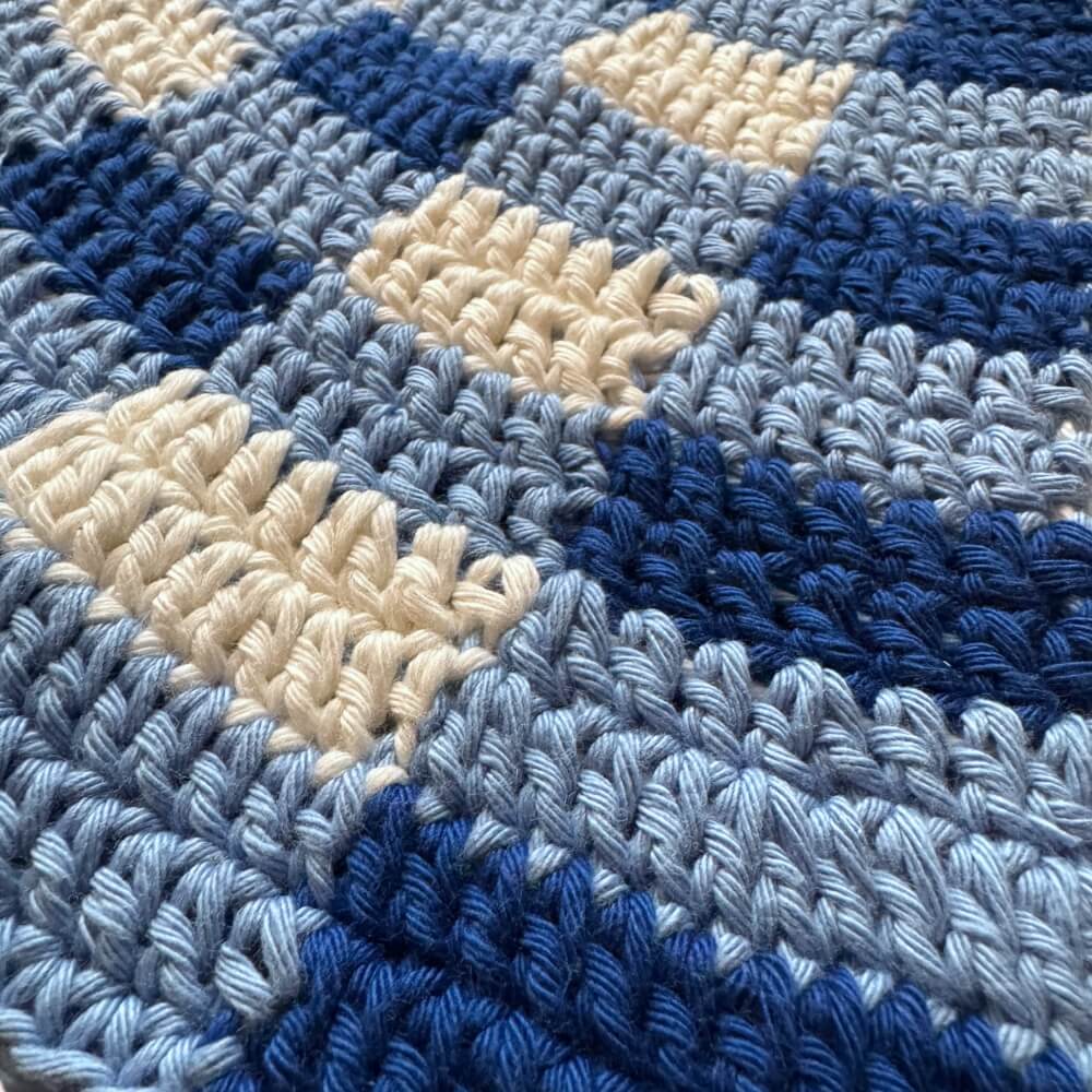 Texture close up of blue gingham crochet bucket hat