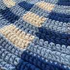 Texture close up of blue gingham crochet bucket hat