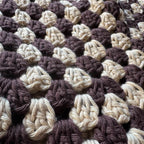 Up close texture shot of brown striped crochet bucket hat 