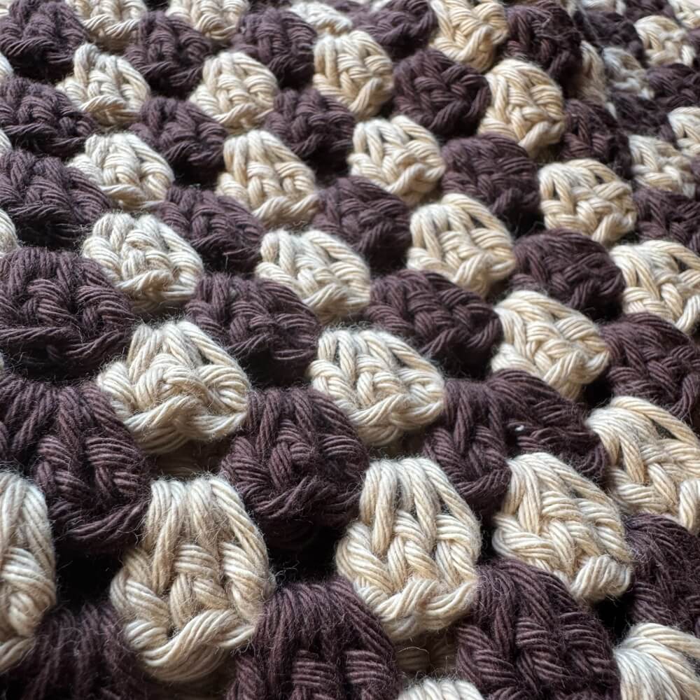 Up close texture shot of brown striped crochet bucket hat 