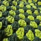 Up close texture shot of green striped crochet bucket hat 