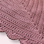Up close texture shot of pink crochet bandana