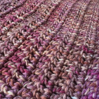 Up close texture shot of pink crochet book sleeve