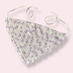 White, pastel pink and pastel purple crochet bandana on plain background