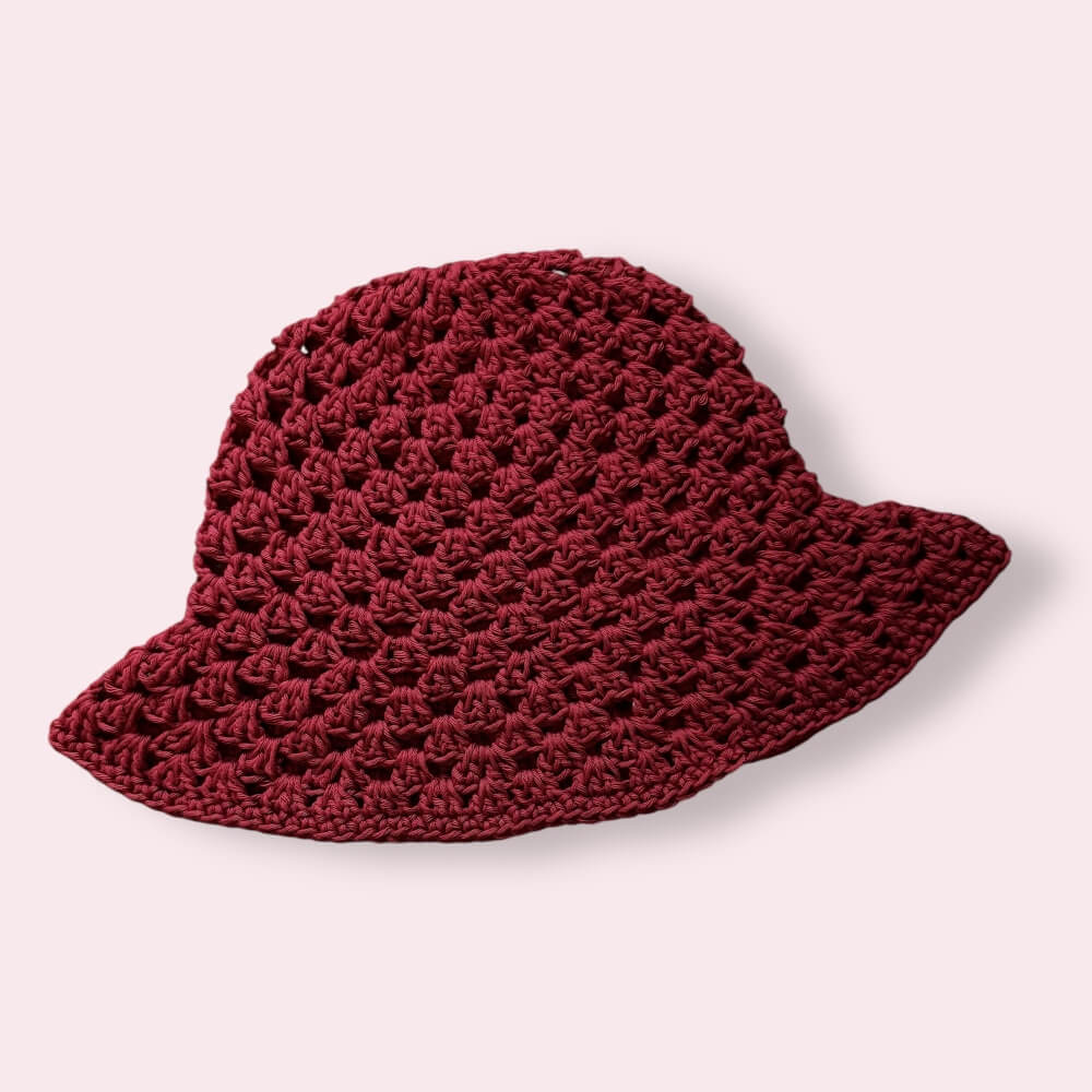 Wine red crochet bucket hat on plain background
