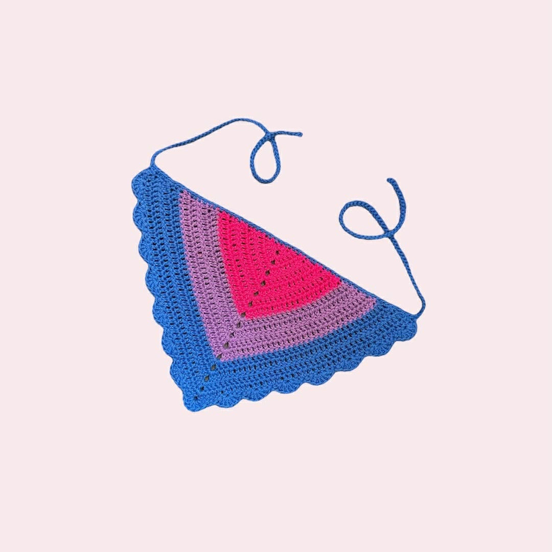 crochet bandana in bi pride colors on a pink background